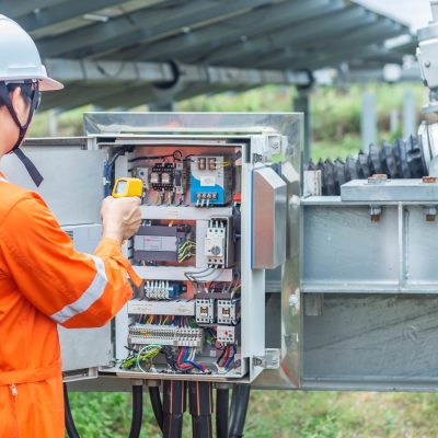 Engineers used a Thermo gun for checking the temperature of the equipment to confirming systems working normally. Concepts professional engineer for the Solar cell power plant.