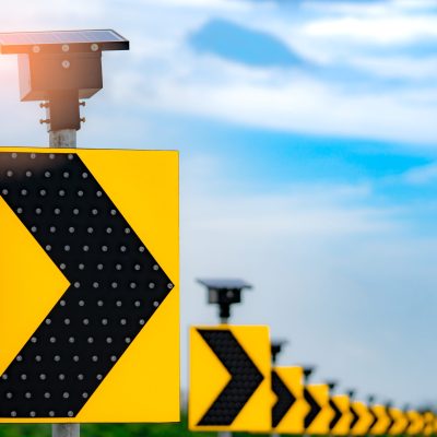 Traffic sign with solar cell panel power on blue sky and clouds background. Electric pole with solar energy. Green energy concept. Renewal energy. Alternative electricity source. Sustainable resources